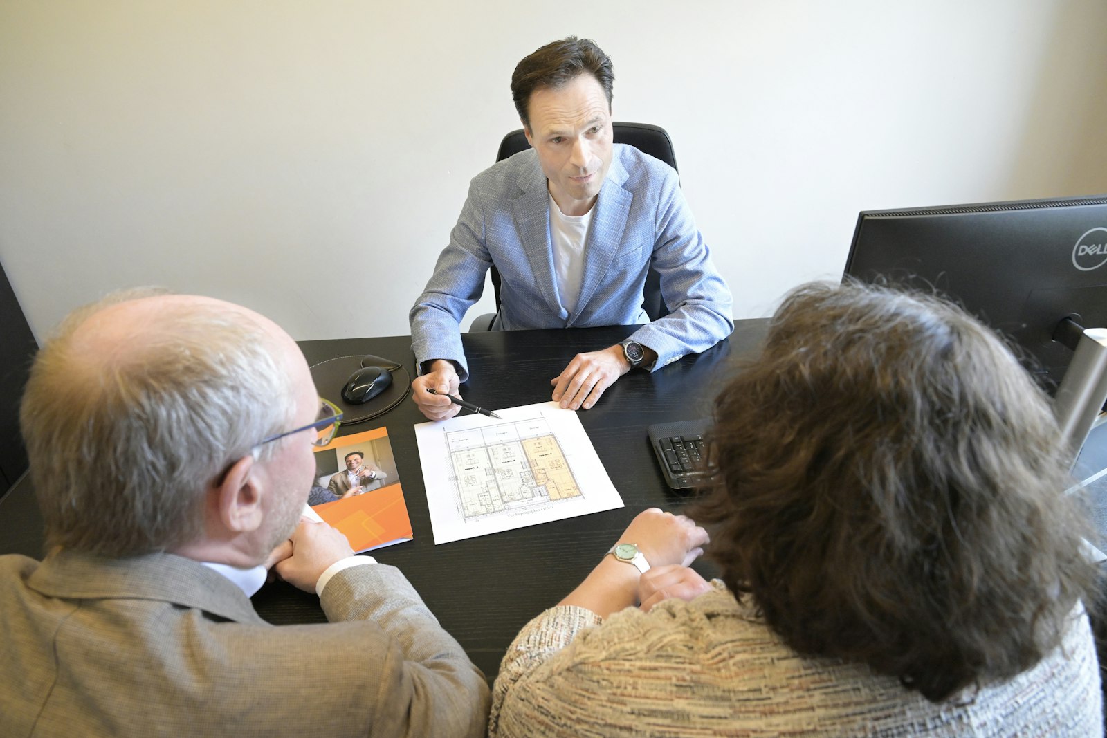 Attorney meeting with clients to review documents