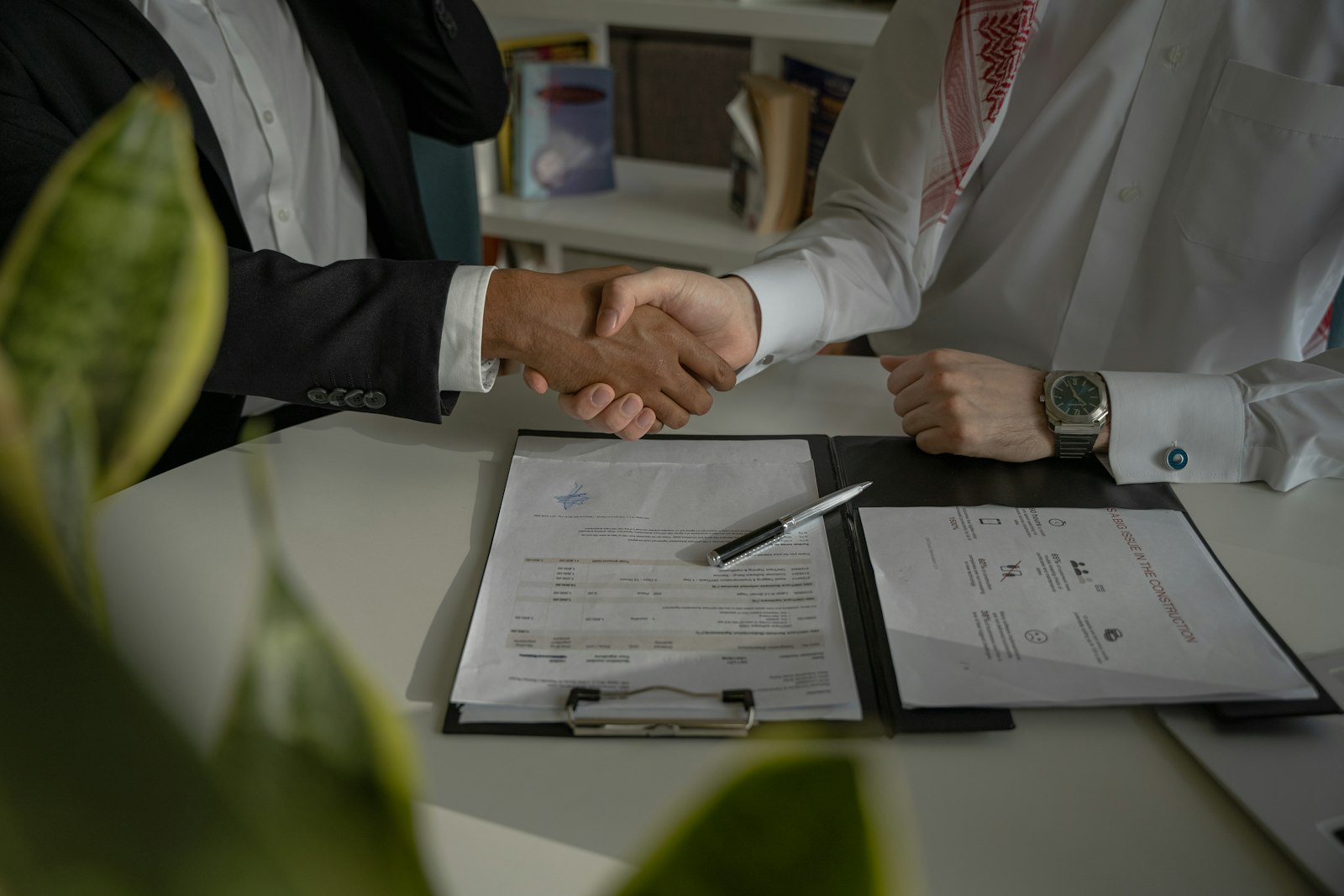 Two parties shaking hands after reaching an agreement